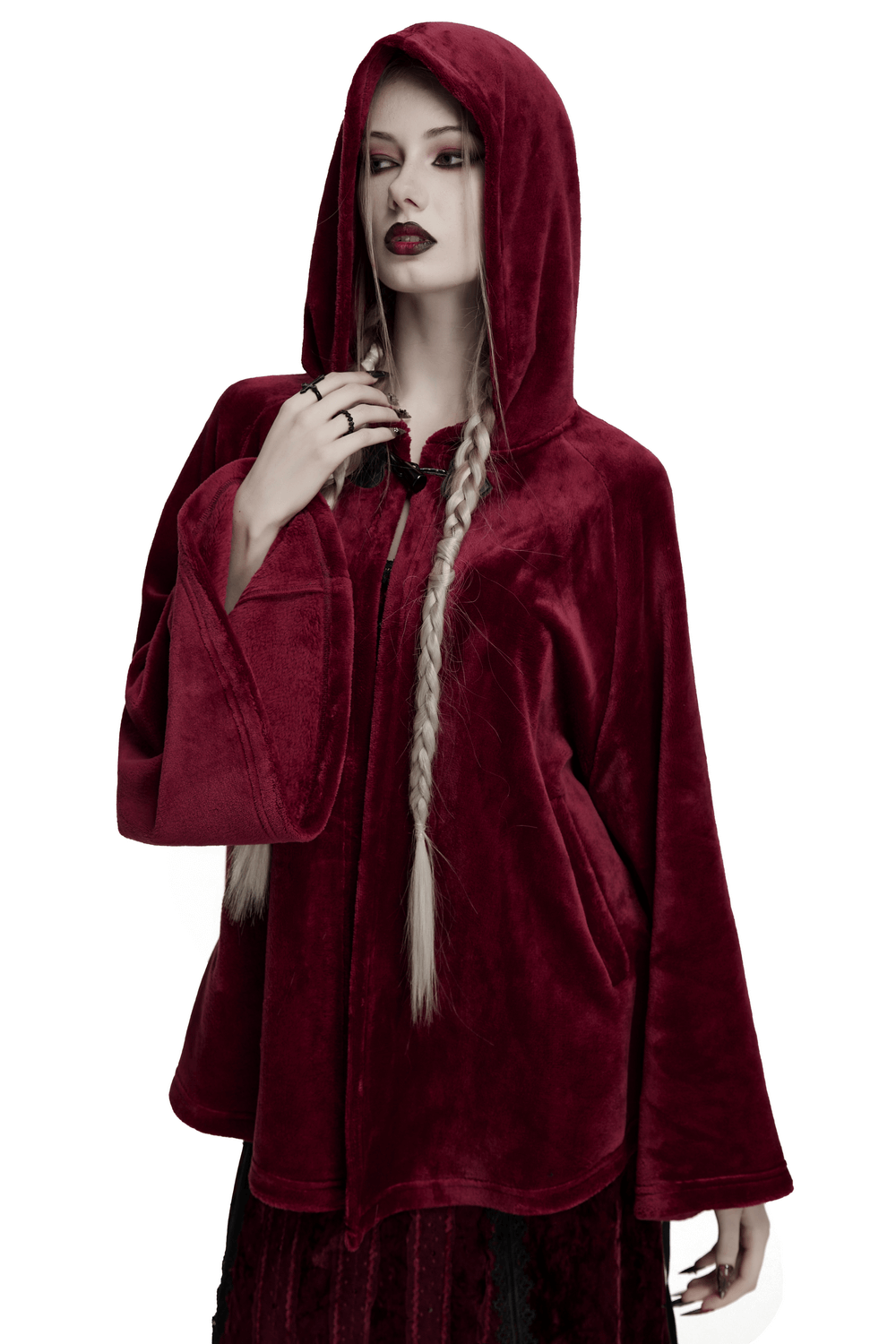 Stylish model wearing a dark velvet hooded cape, showcasing the flowing design and unique hood detail.