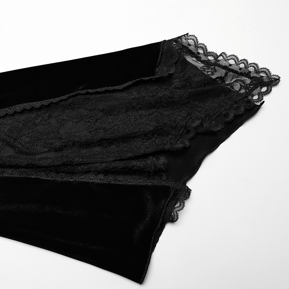 Close-up of the elegant black velvet and lace detailing on gothic dress sleeves.