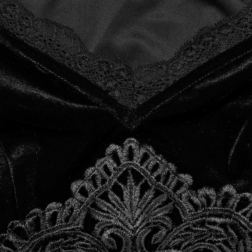 Close-up of elegant black velvet lace with intricate decal detail on a Gothic dress.