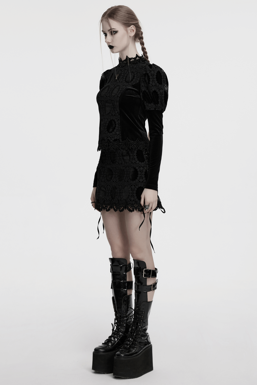 Stylish model wearing a velvet lace top with puff sleeves, paired with edgy platform boots for a chic look.