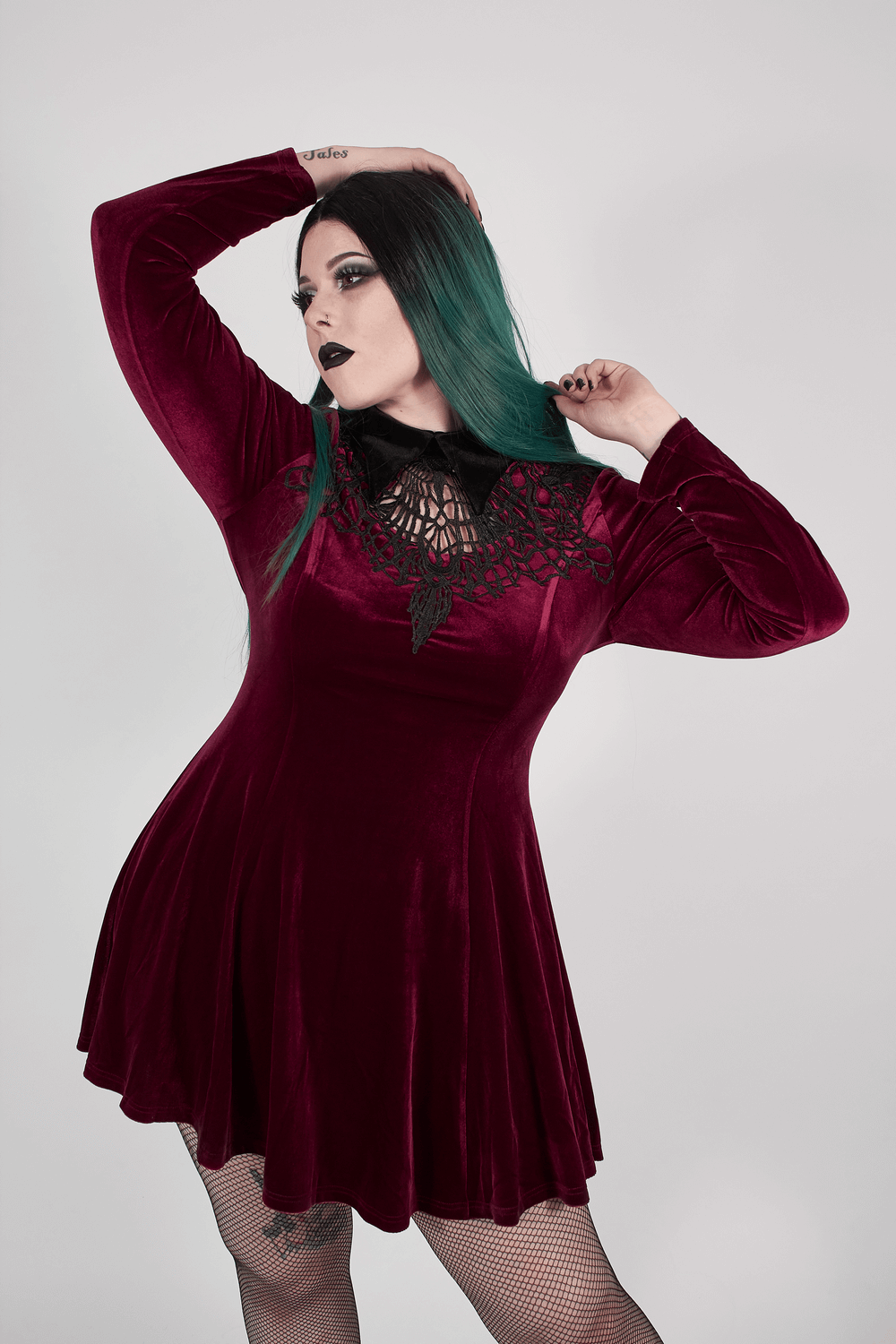 Gothic velvet lace-up dress in deep burgundy, featuring a lace neckline and flowing skater silhouette.