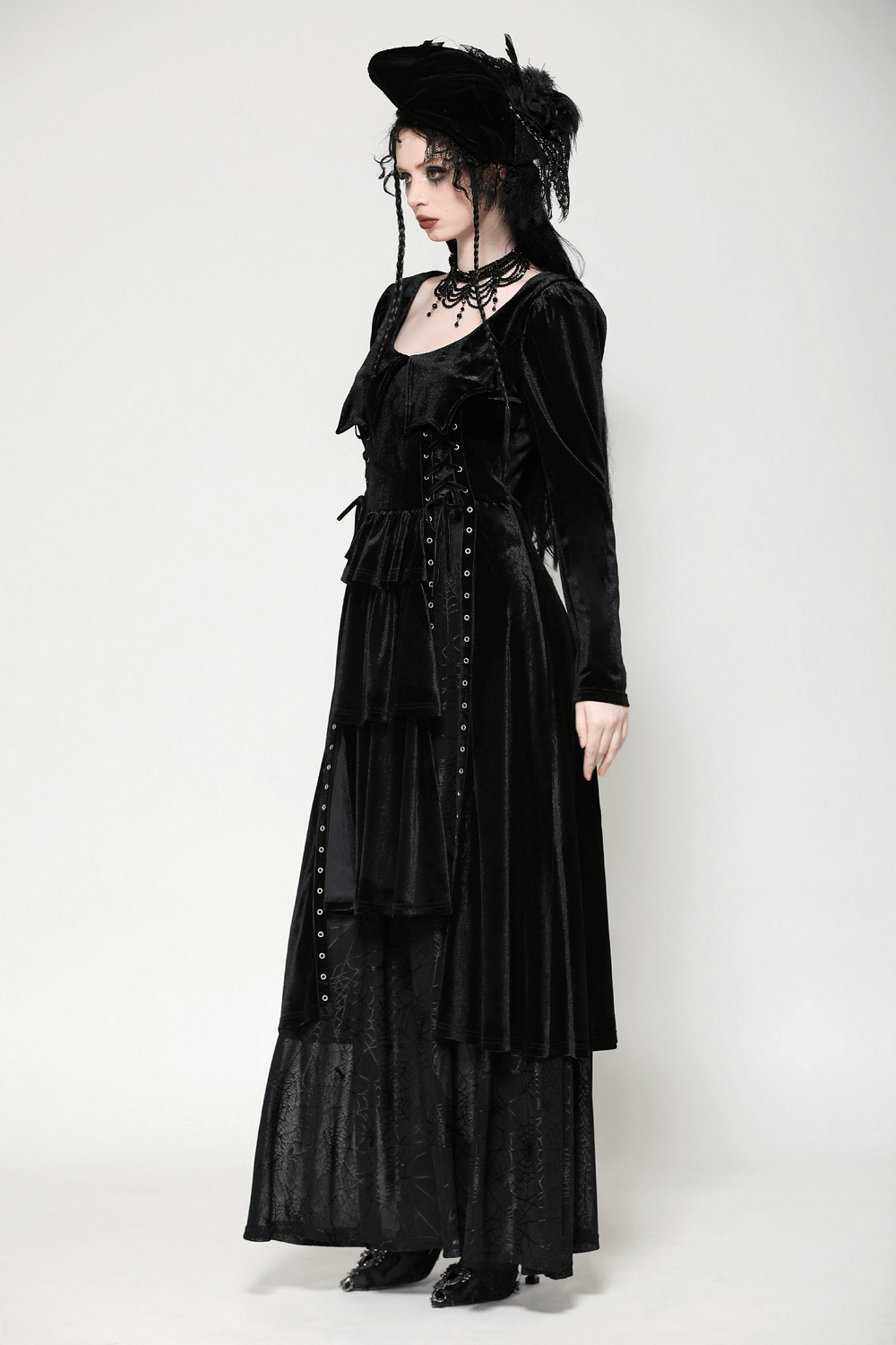 Elegant model in a black velvet lace-up gothic dress, featuring dramatic mesh details and Victorian-inspired accents.