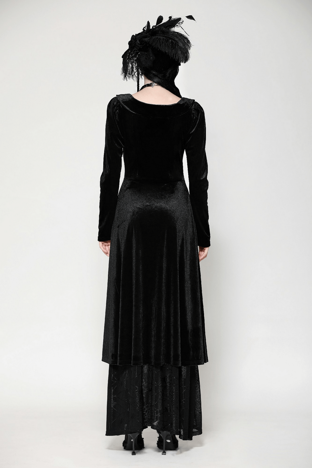 Back view of a Victorian-inspired black velvet gothic dress with mesh panel details and elegant long sleeves.