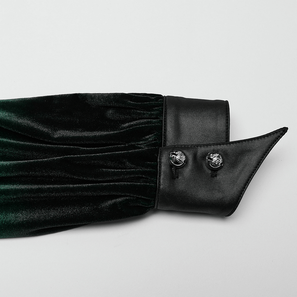 Close-up of velvet shirt sleeve with bat collar, featuring floral-carved buttons and soft, elastic fabric.
