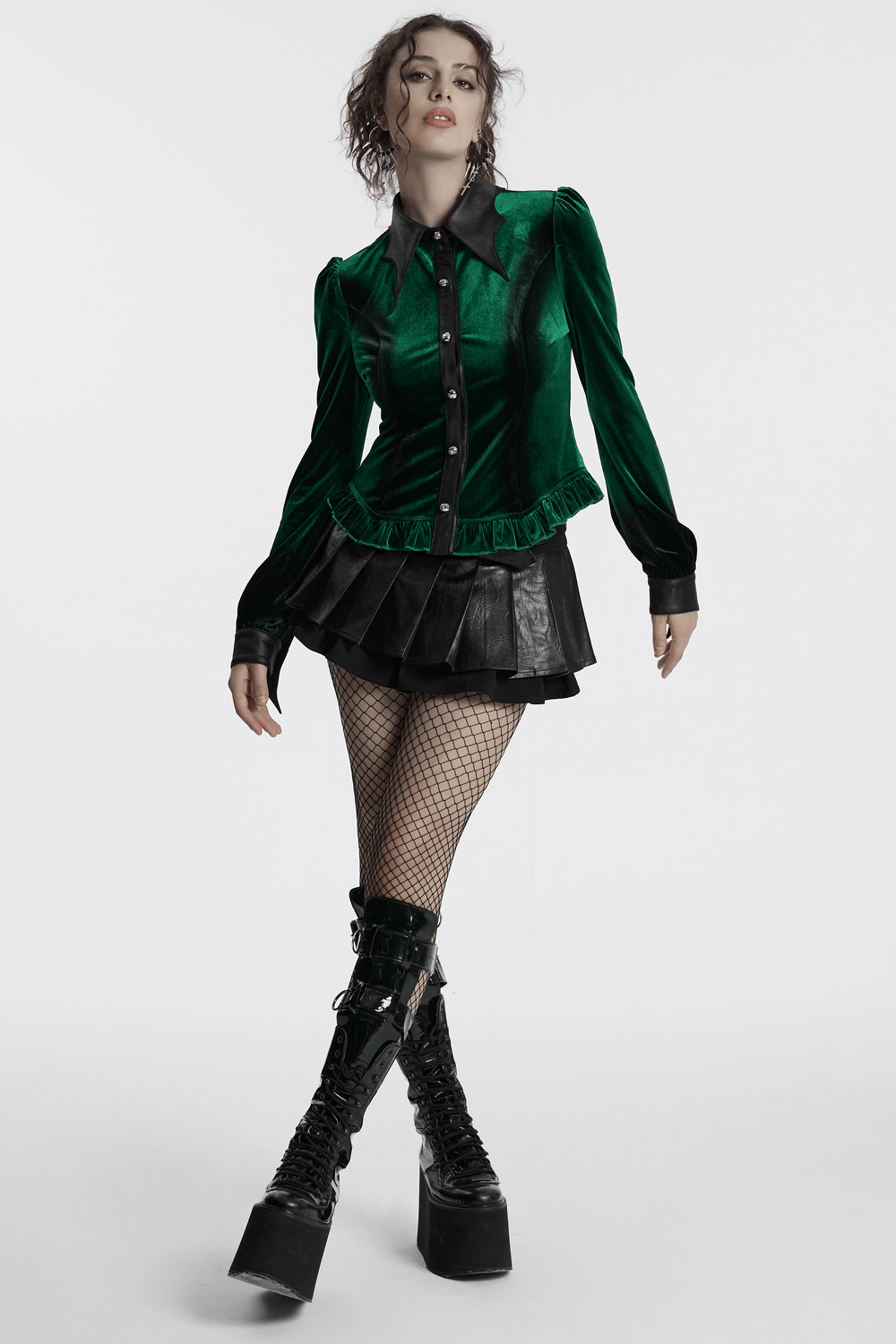 Goth velvet shirt with bat collar in striking green, paired with a black skirt and fishnet stockings, exuding edgy elegance.