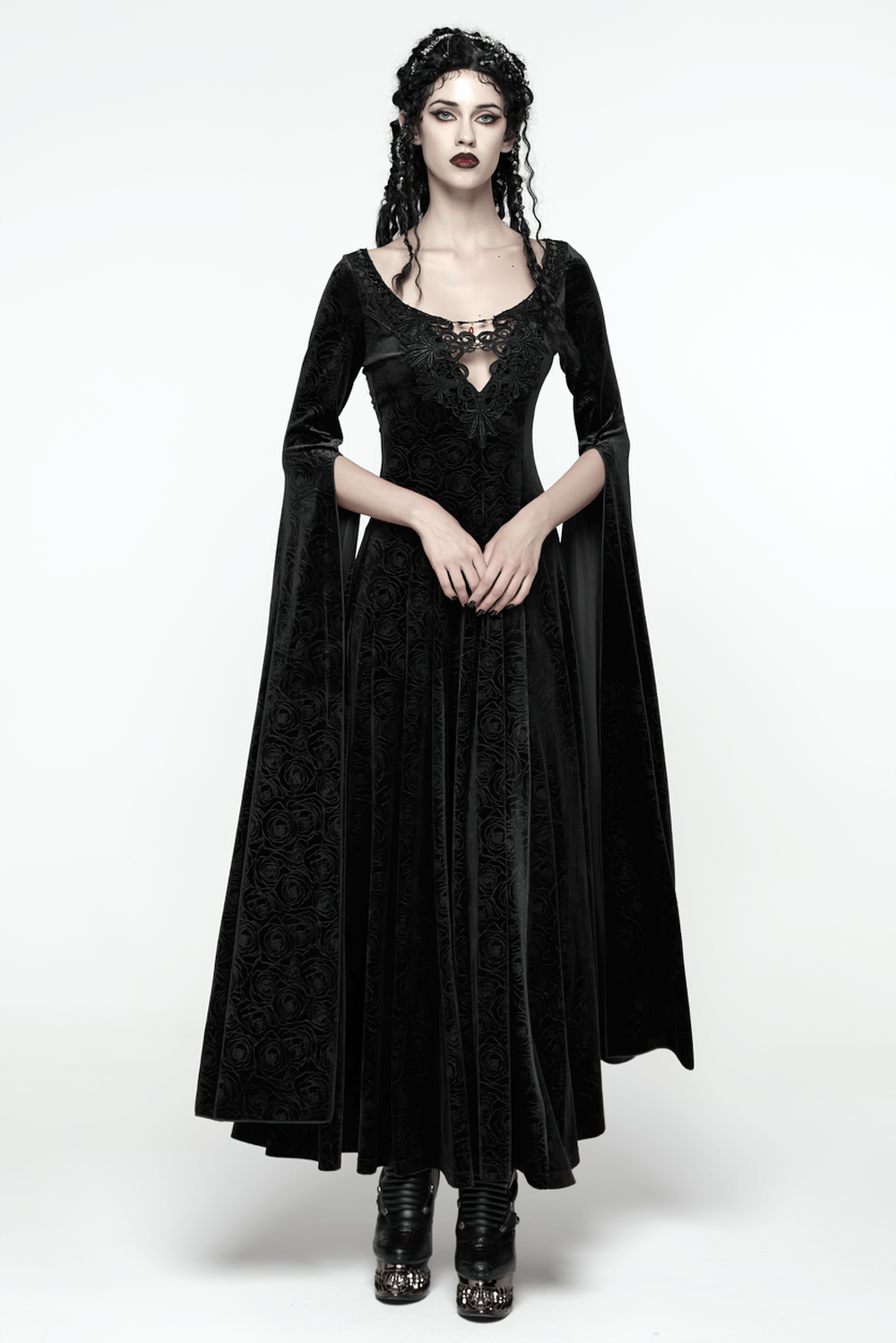 Velvet Long Dress with Gem Appliqué and Flared Sleeves worn by a model, showcasing dark elegance and flowing sleeves.