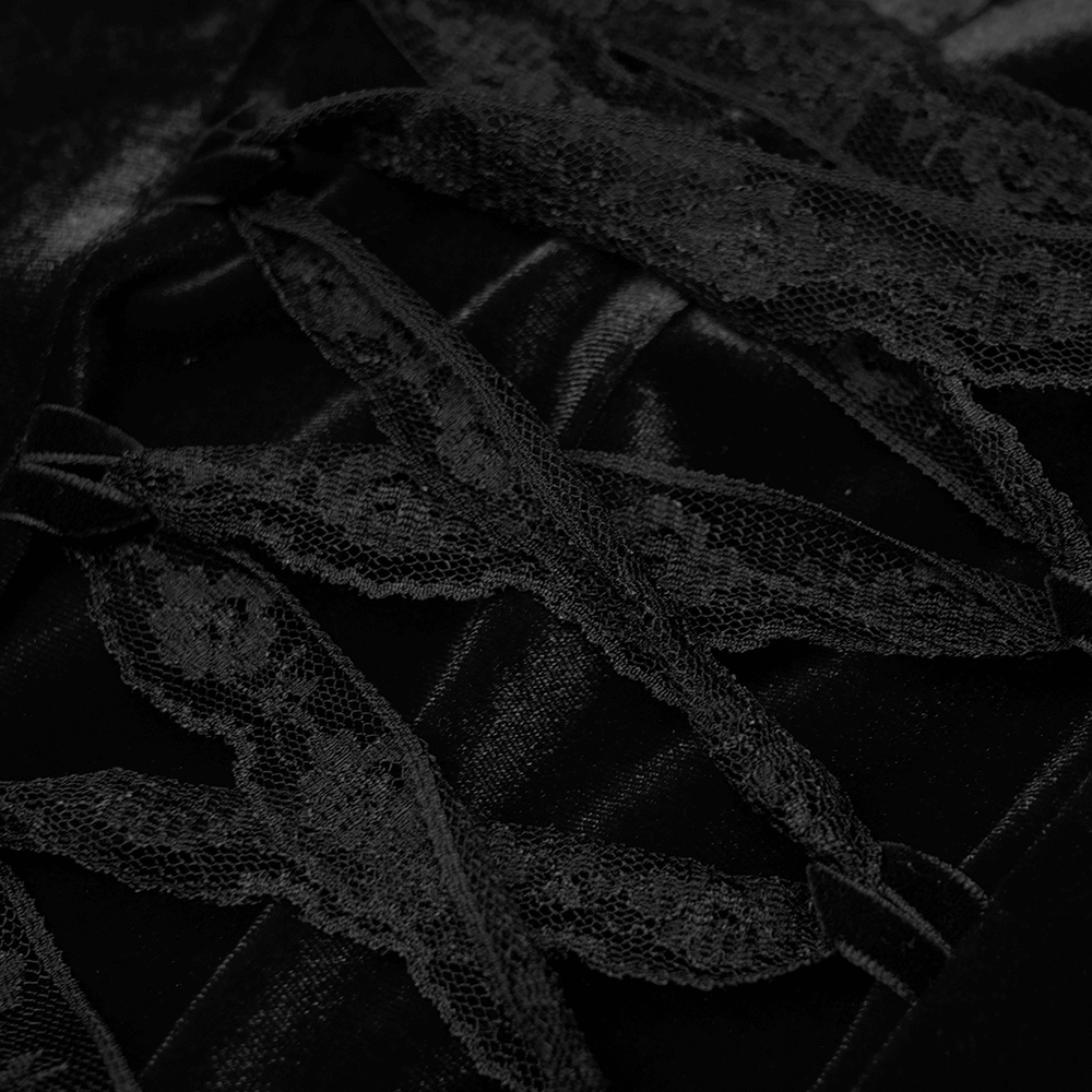 Close-up of black velvet dress details featuring lace trim and ribbon accents, showcasing gothic elegance.