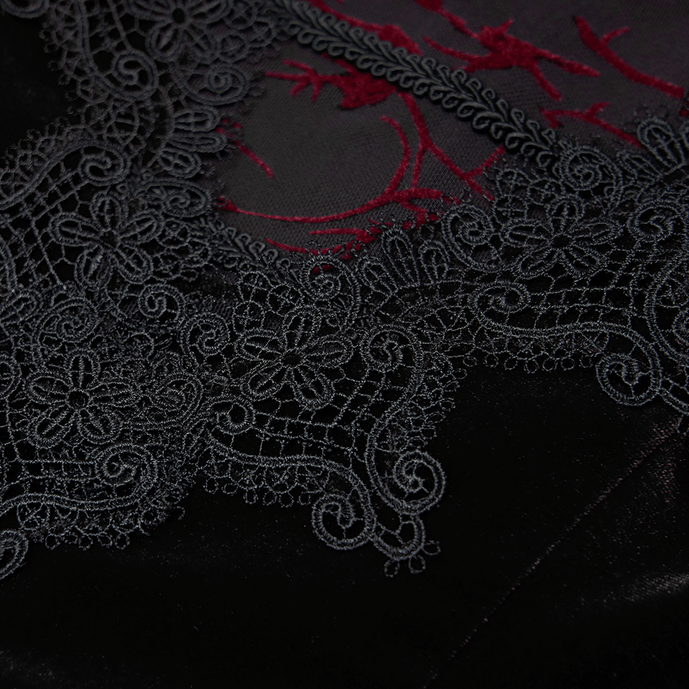 Intricate black lace trim detail on velvet fabric, showcasing elegant gothic design elements.