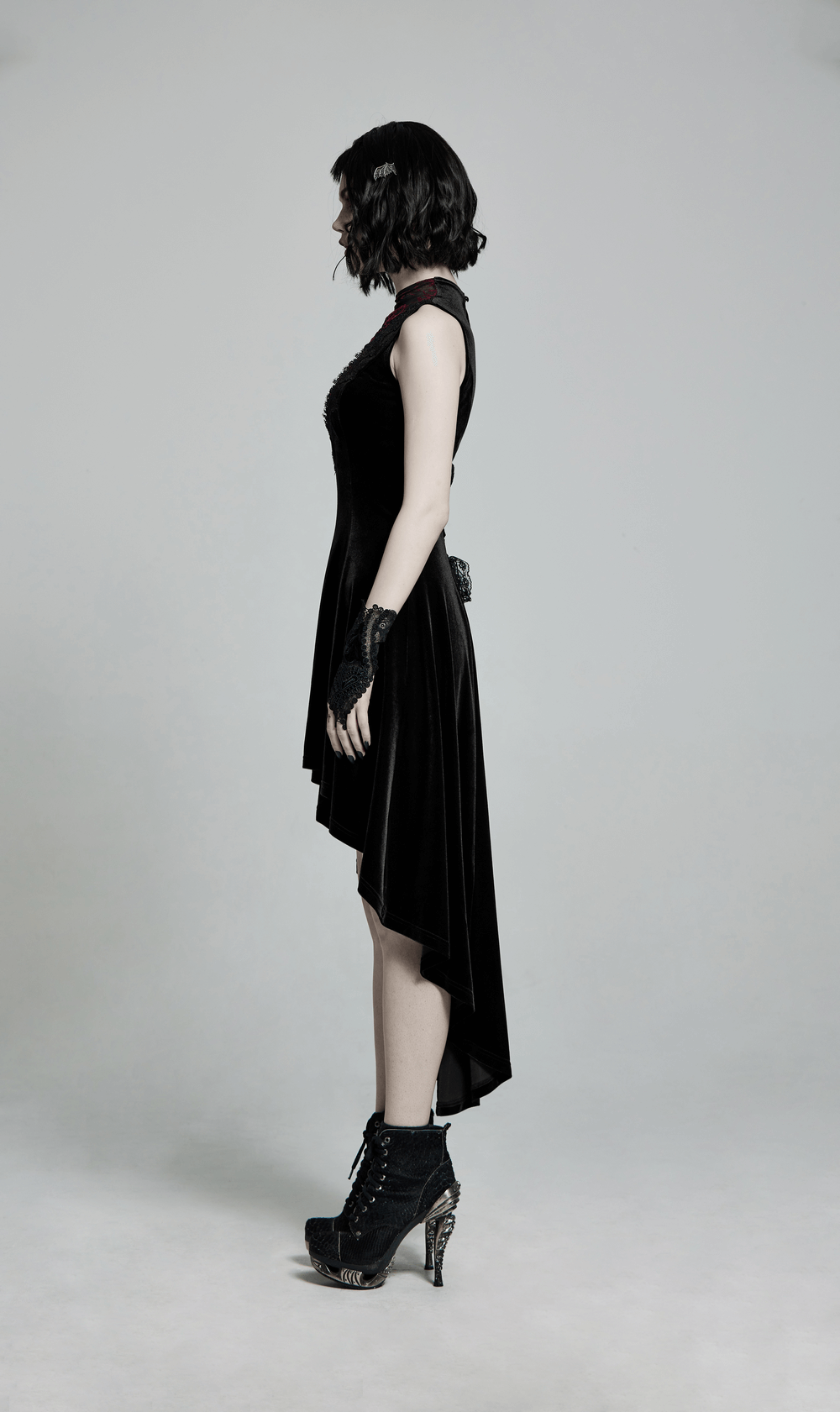 Side view of Gothic sleeveless high-low velvet dress with lace trim, exuding elegance and a snug silhouette.
