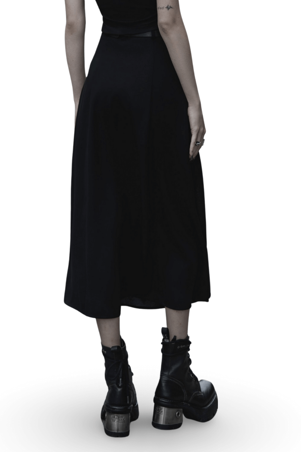 Back view of a versatile black A-Line midi skirt with side zipper detail and stylish boots.