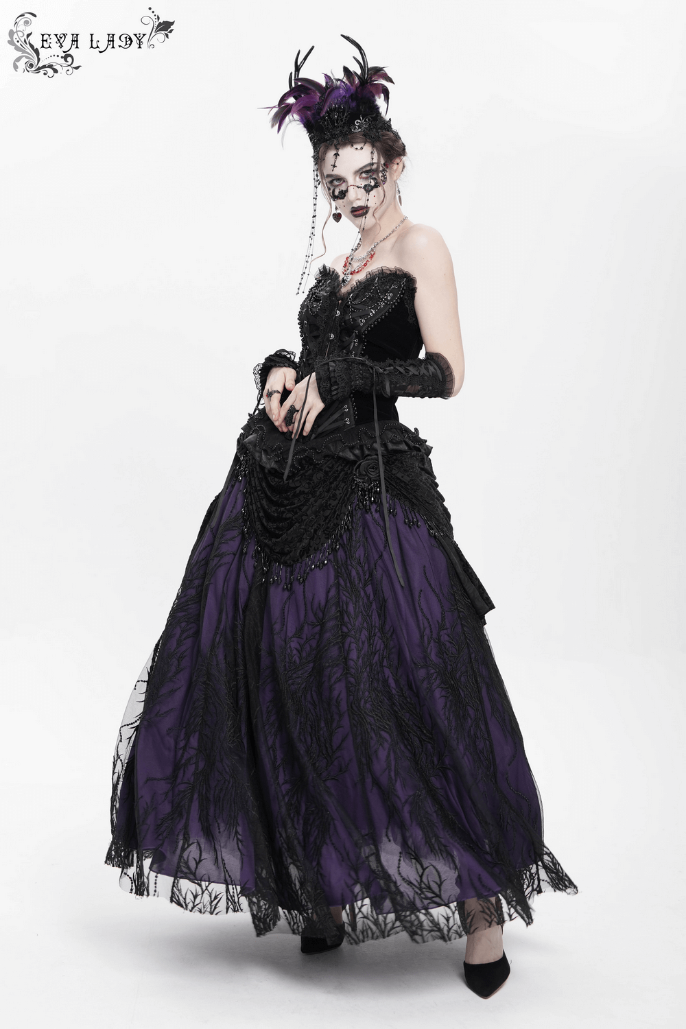 Elegant model in a Victorian beaded overlay skirt with floral appliqué, featuring gothic black and purple lace details.