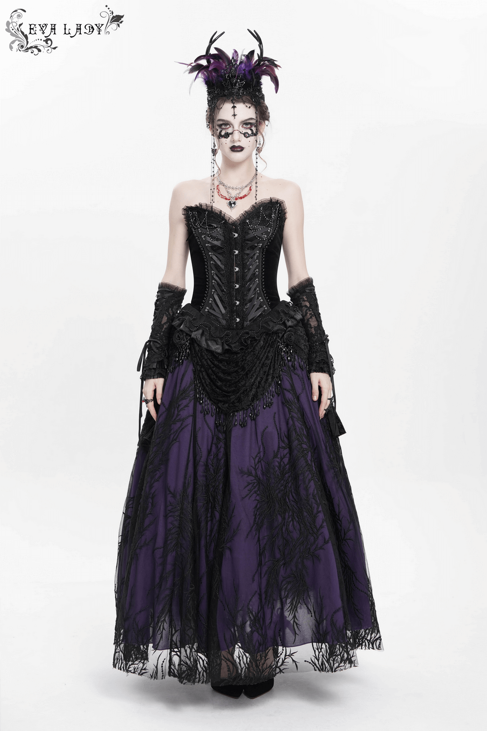Gothic model wearing a Victorian beaded overlay skirt with floral appliqué, featuring black lace and deep purple layers.