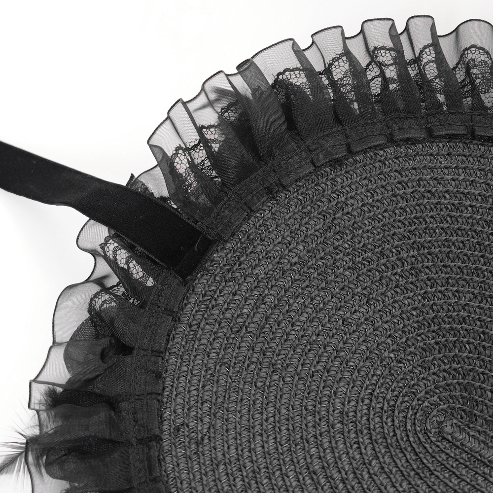 Close-up of the ruffled trim and velvet ribbon ties on an elegant black feather Victorian bonnet.