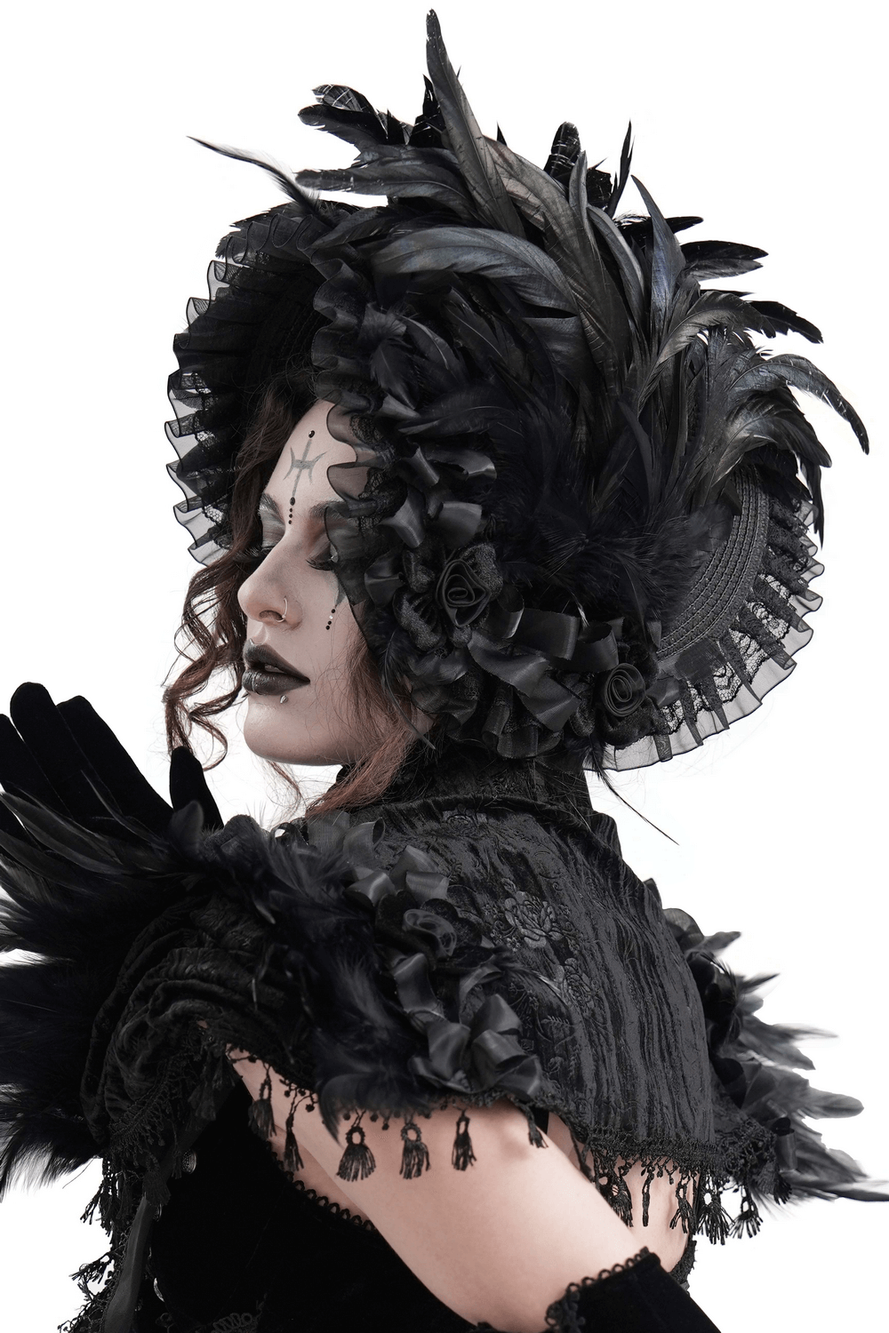 Victorian black feather bonnet with ruffled trim and velvet ribbon ties, perfect for gothic and steampunk costumes.