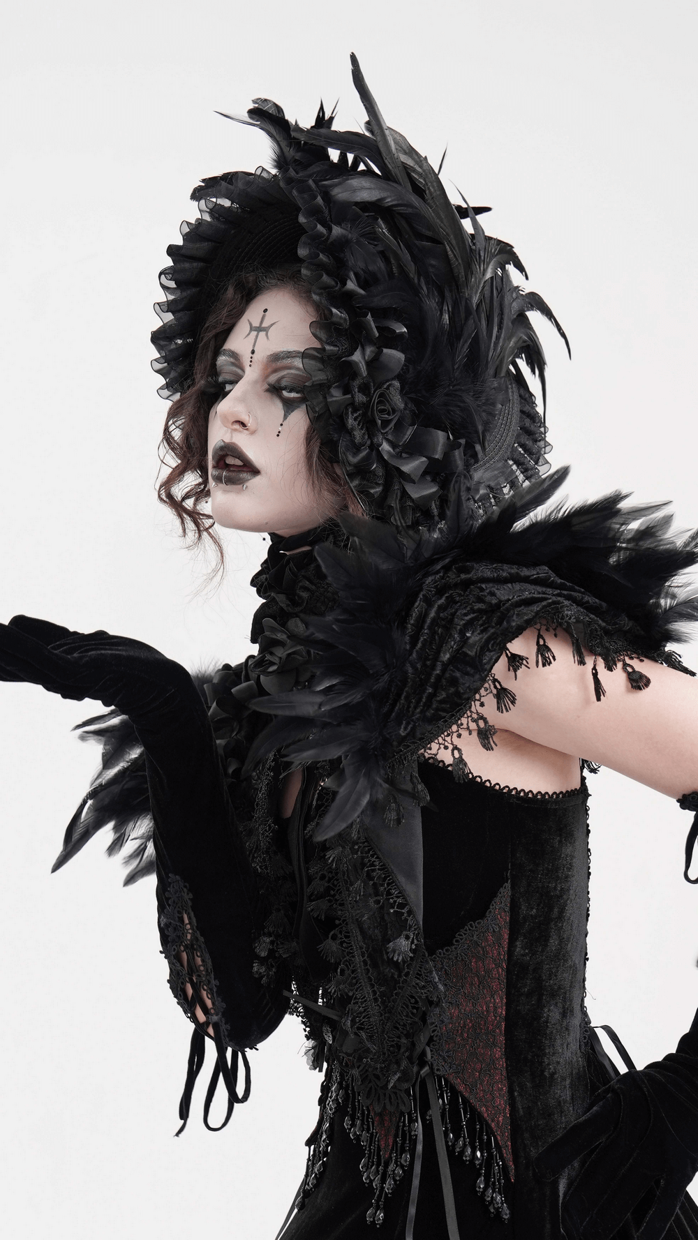 Elegant model wearing a Victorian black feather bonnet with ruffled trim and velvet ribbon ties, showcasing gothic fashion.