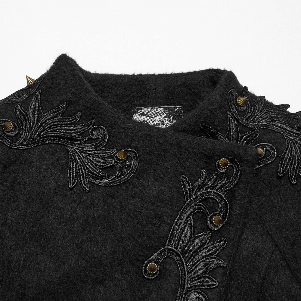 Close-up of ornate gothic black coat showing baroque appliques and pointed studs on collar.
