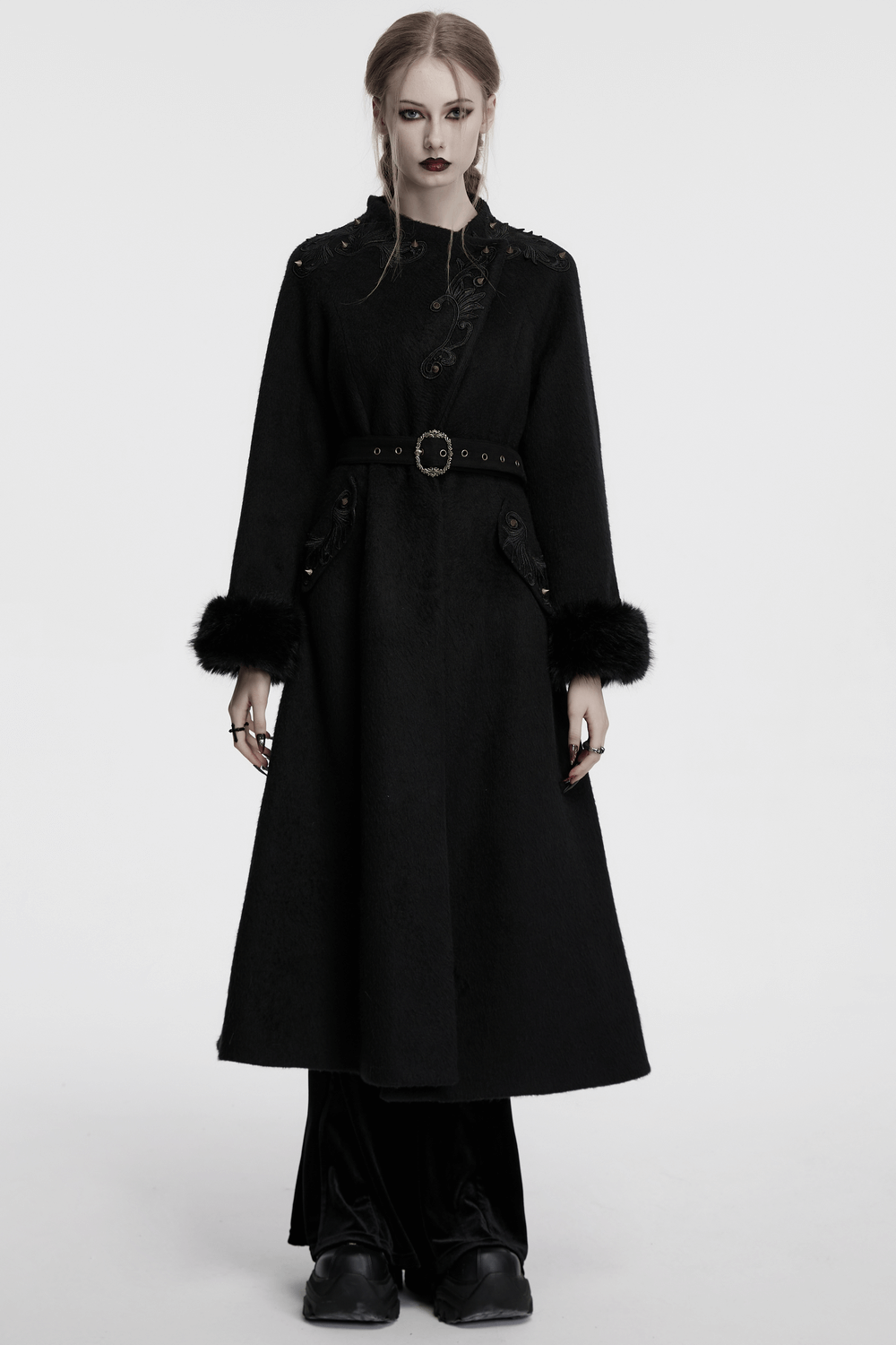 Victorian black long coat with belt and fur cuffs, featuring gothic appliques and pointed studs, perfect for winter.