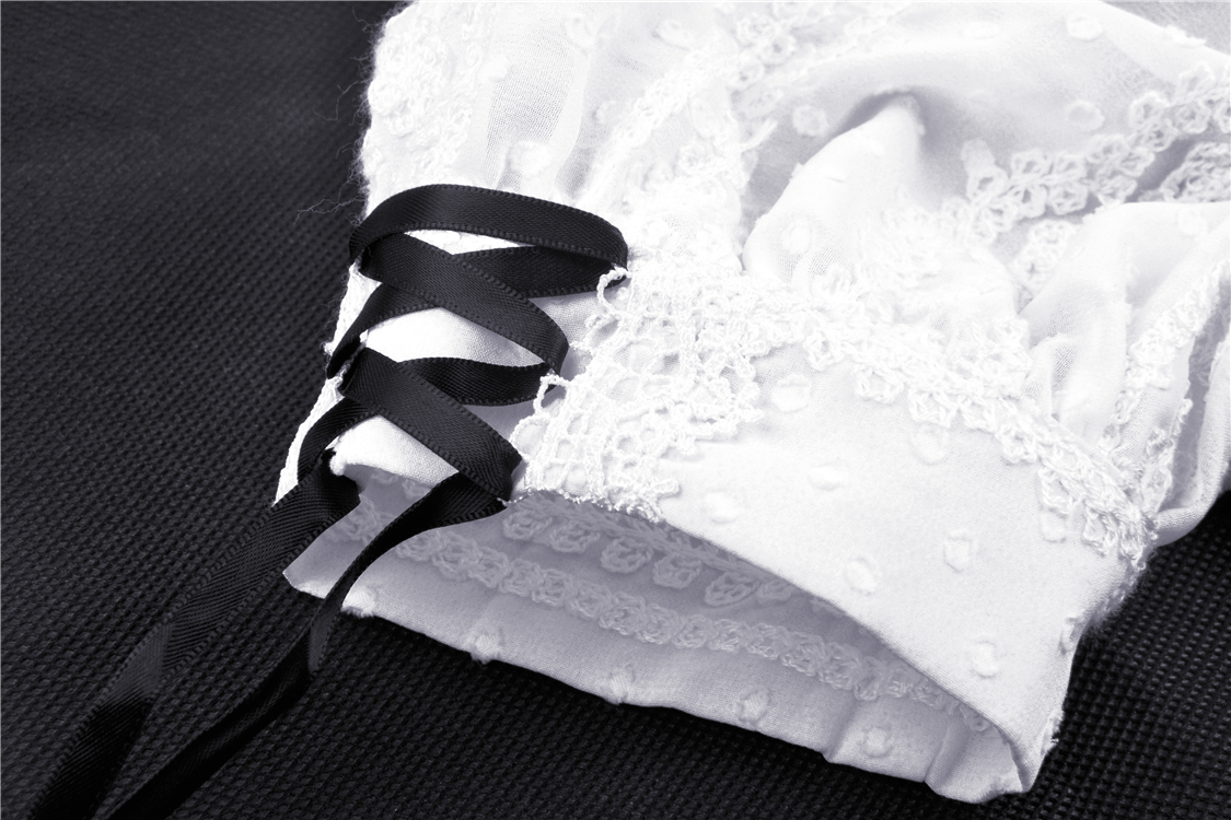 Close-up of a white lace collar with black ribbon detailing, perfect for a gothic dress.
