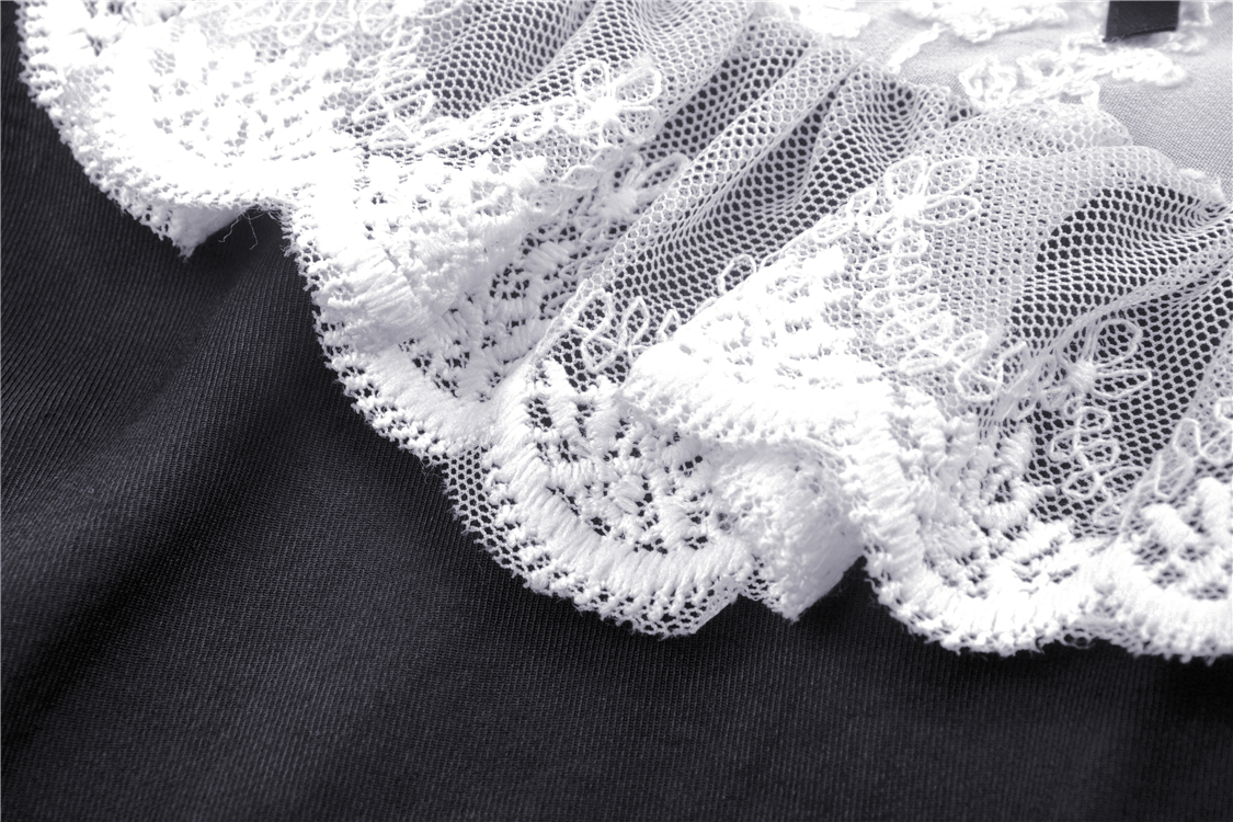 Close-up of the delicate white lace collar on a black Gothic Lolita dress, featuring intricate ribbon details.