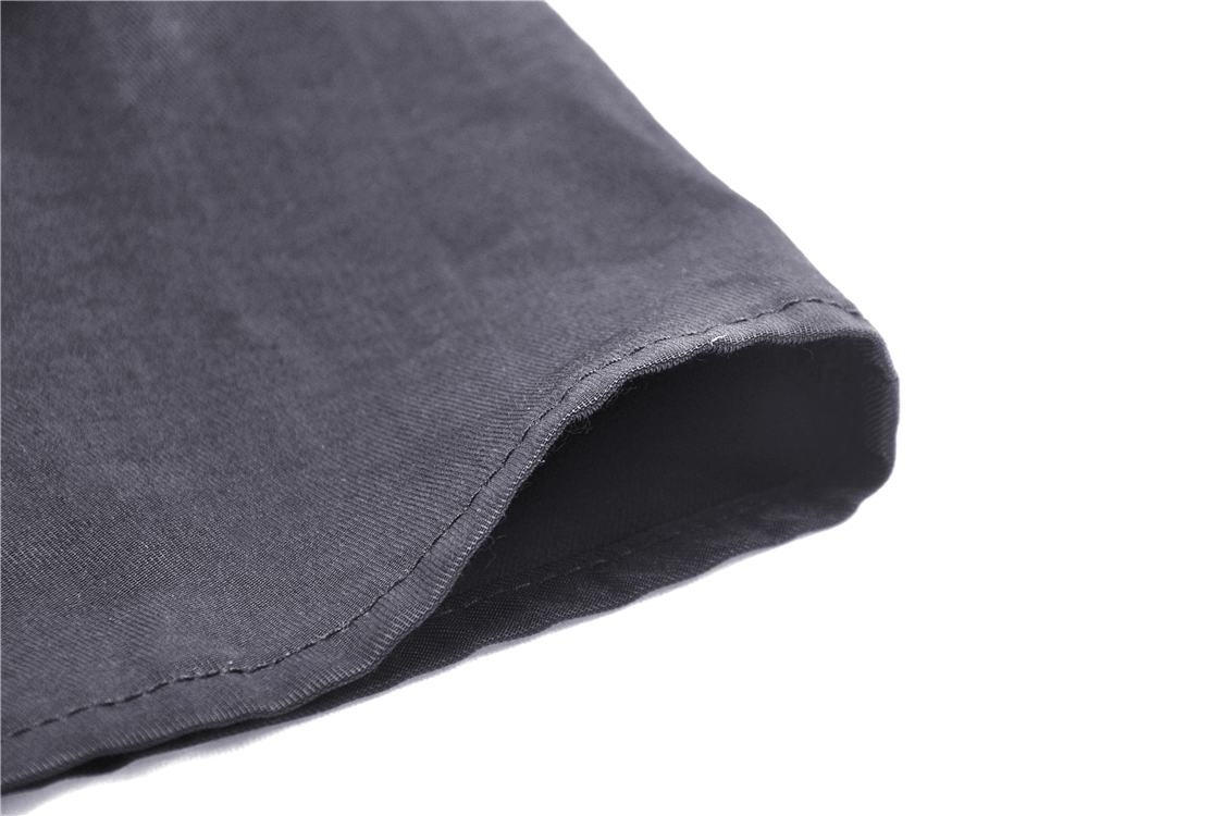 Close-up of black fabric hem showcasing fine stitching details of a midi dress.