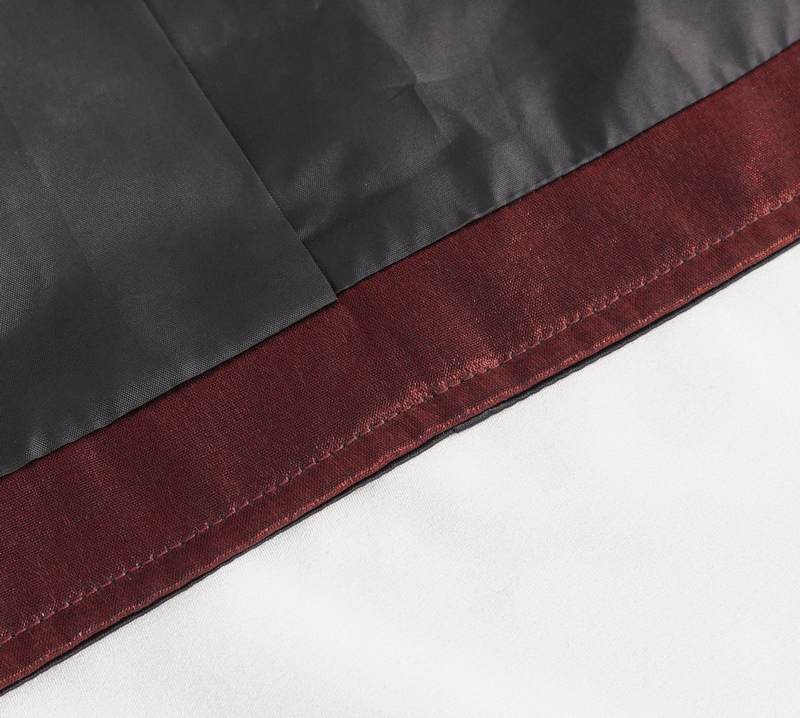 Close-up of luxurious fabric detail showcasing deep burgundy and black satin layers for elegant waistcoat design.