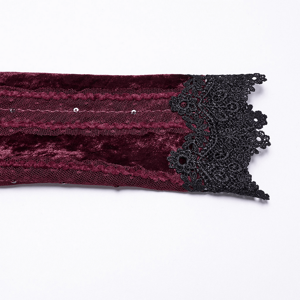 Close-up of burgundy velvet fabric with lace trim, showcasing vintage elegance and gothic style details.