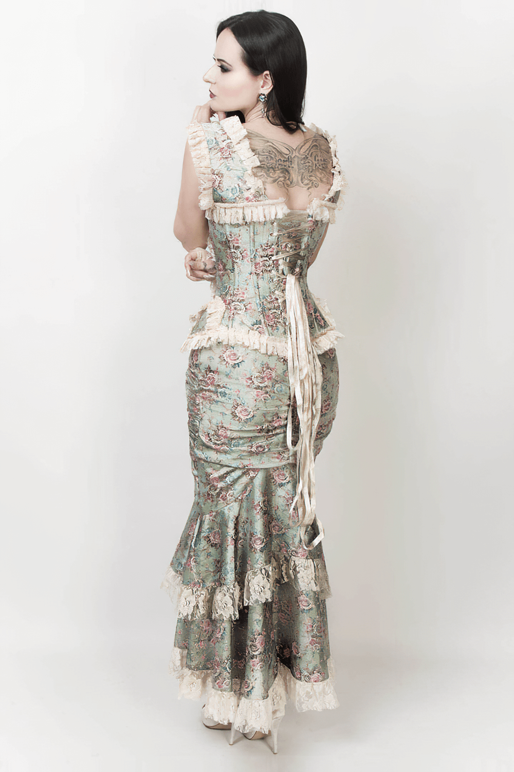 Rear view of an elegant Victorian bustle skirt with floral lace trim, showcasing its vintage-inspired design.