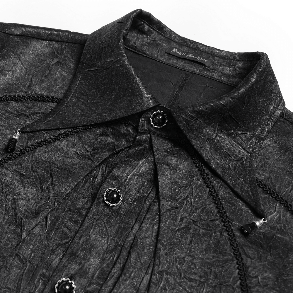 Victorian Goth Button Shirt With Cameo and Cross Brooch close-up showing black textured fabric and buttons.