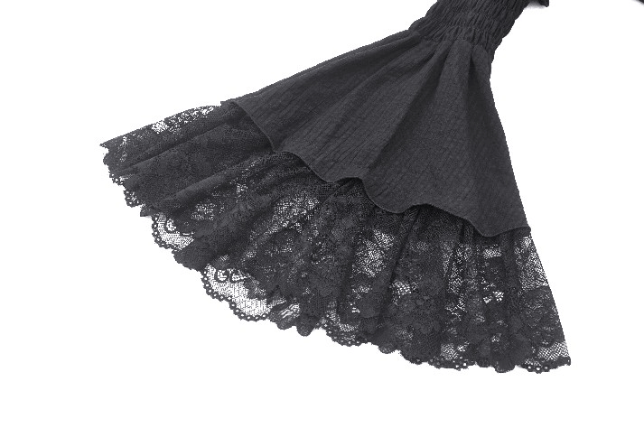 Close-up of the ruffled lace hem of a Victorian Gothic black dress, showcasing intricate lace detailing.