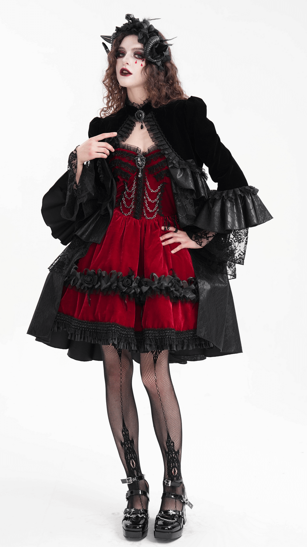 Victorian Gothic black velvet jacket with lace and ruffles styled over a red dress, creating a dramatic gothic look.