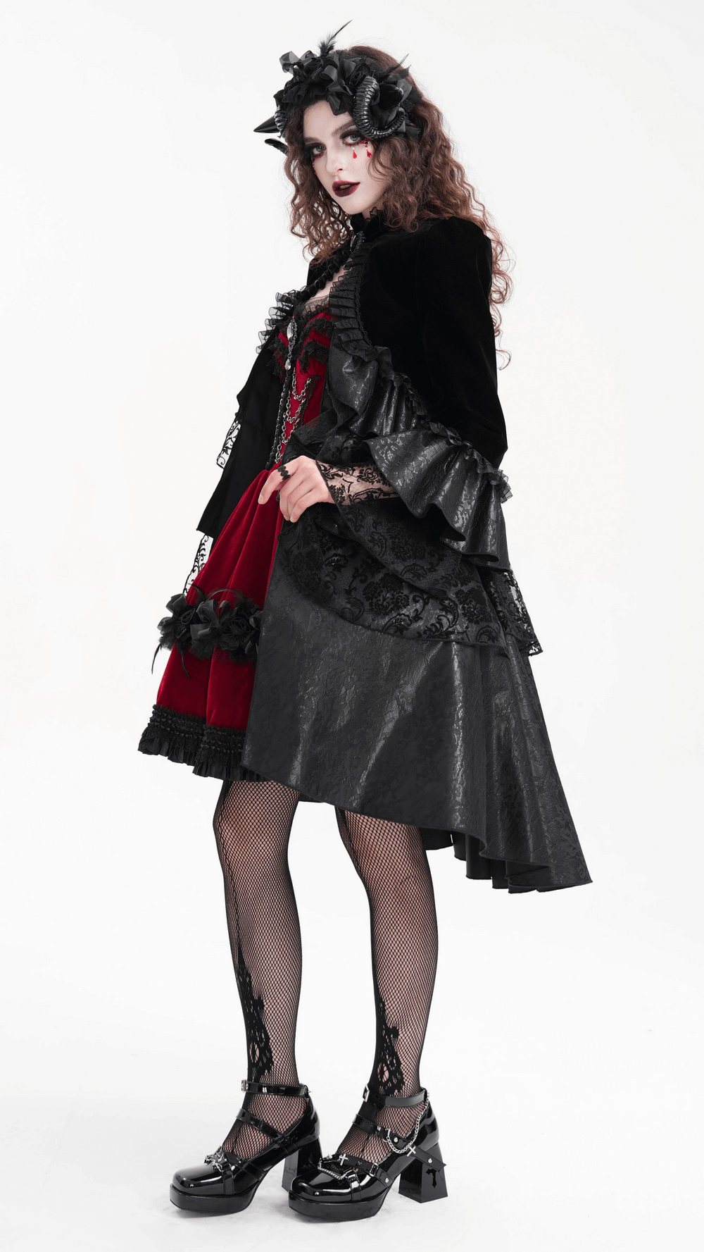 Elegant model in a Victorian Gothic black velvet jacket with lace, ruffles, and a stylish red dress.