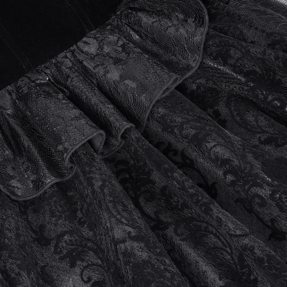 Close-up of delicate lace and ruffled detailing on a black velvet Victorian gothic jacket.