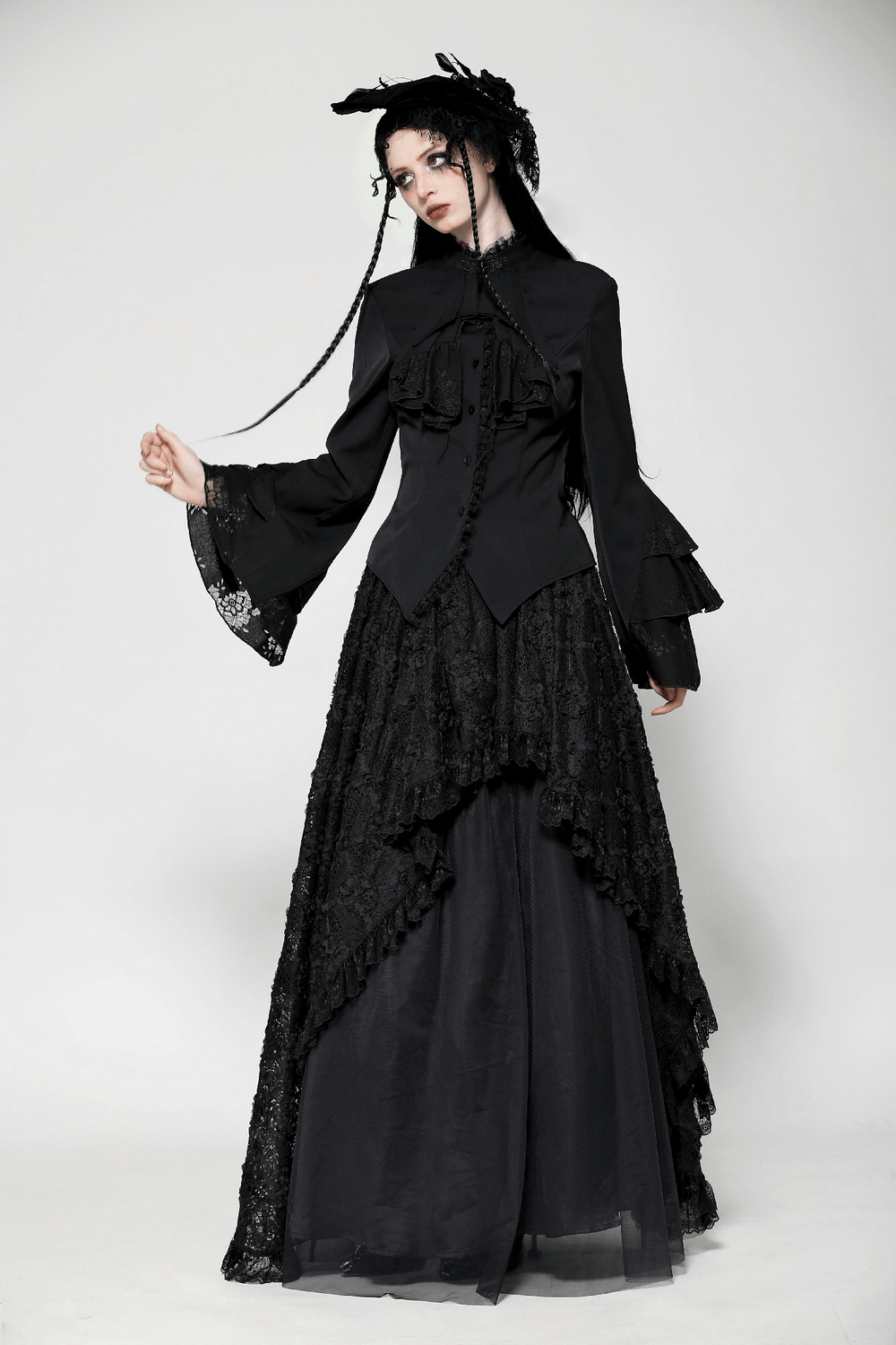 Elegant model in black Victorian gothic blouse with lace and ruffle sleeves, showcasing a tailored fit and high collar.