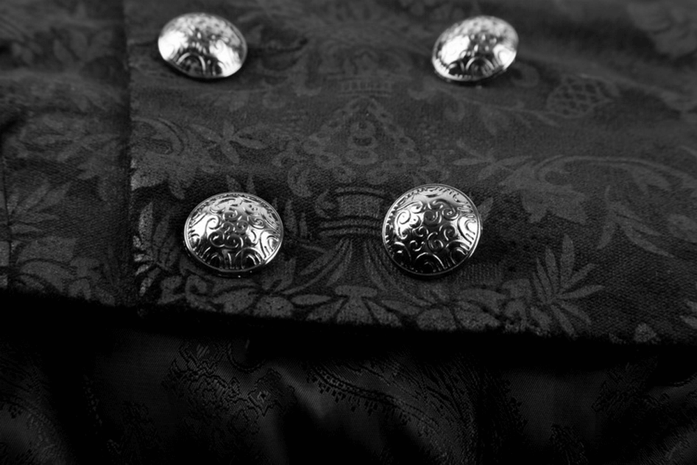 Close-up of intricate silver buttons on a luxurious black velvet waistcoat with gothic dark prints.