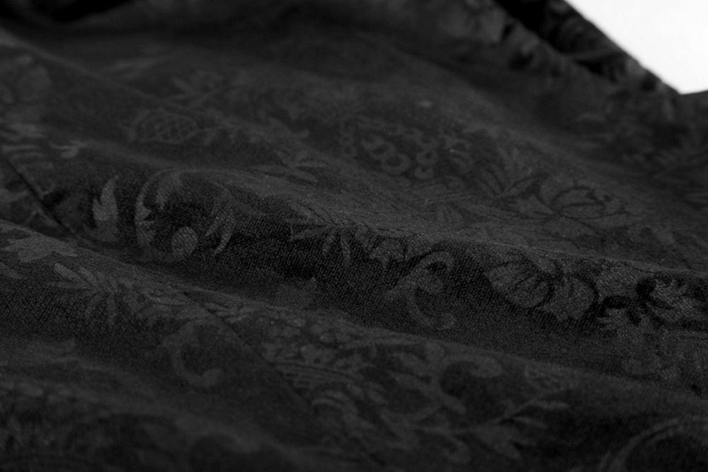Close-up of intricate dark patterned fabric showcasing luxurious Gothic design for Victorian waistcoat.