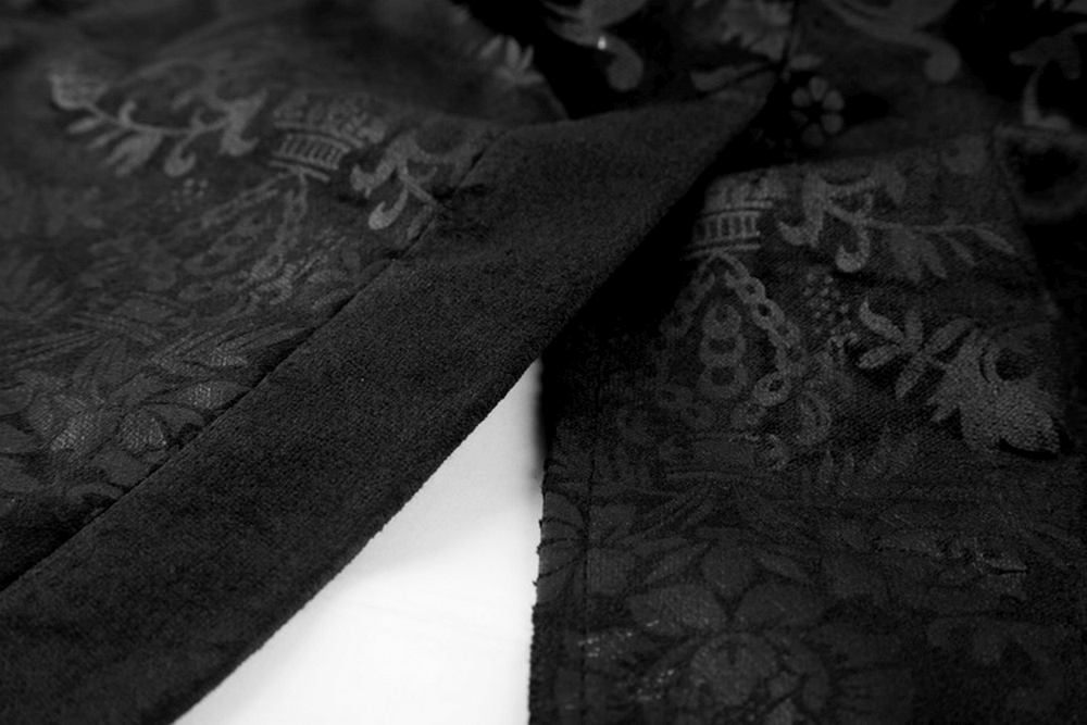 Close-up of luxurious black velvet waistcoat with intricate dark print details, showcasing Victorian gothic style.