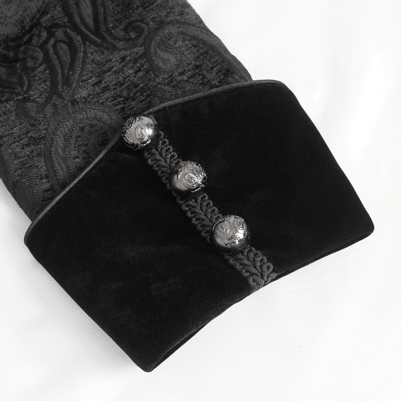 Close-up of the embroidered cuff of a Victorian Gothic jacket with decorative buttons and tassel detailing.