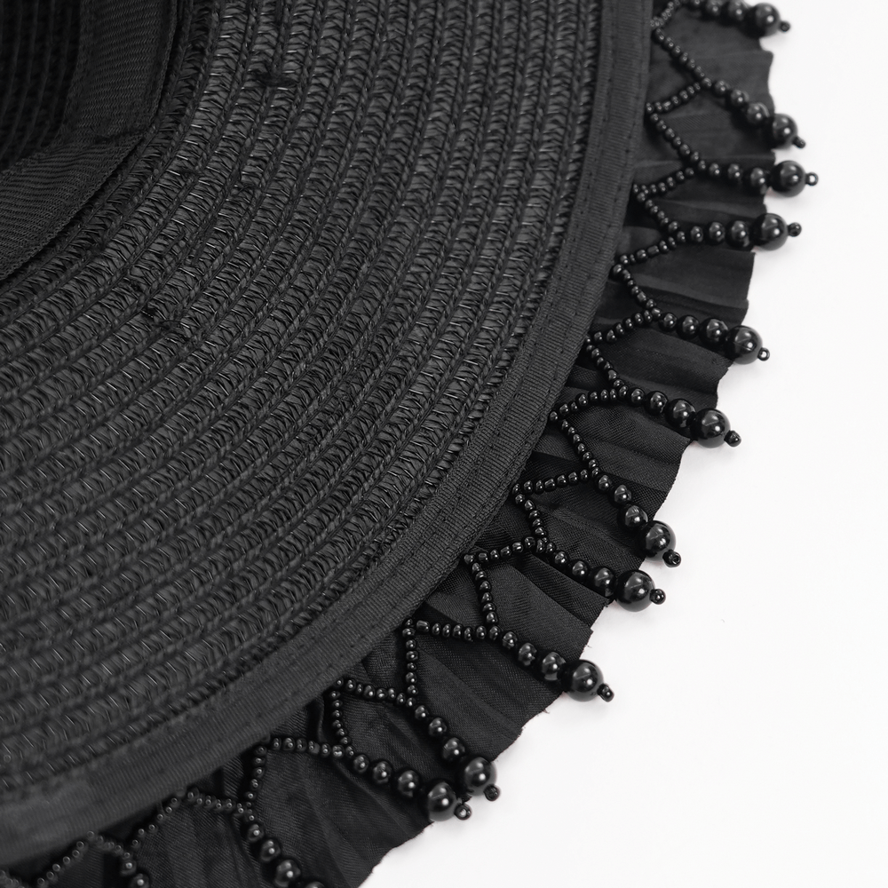 Close-up of a Victorian Gothic hat's black lace trim adorned with elegant beaded detailing. Perfect for dramatic fashion statements.