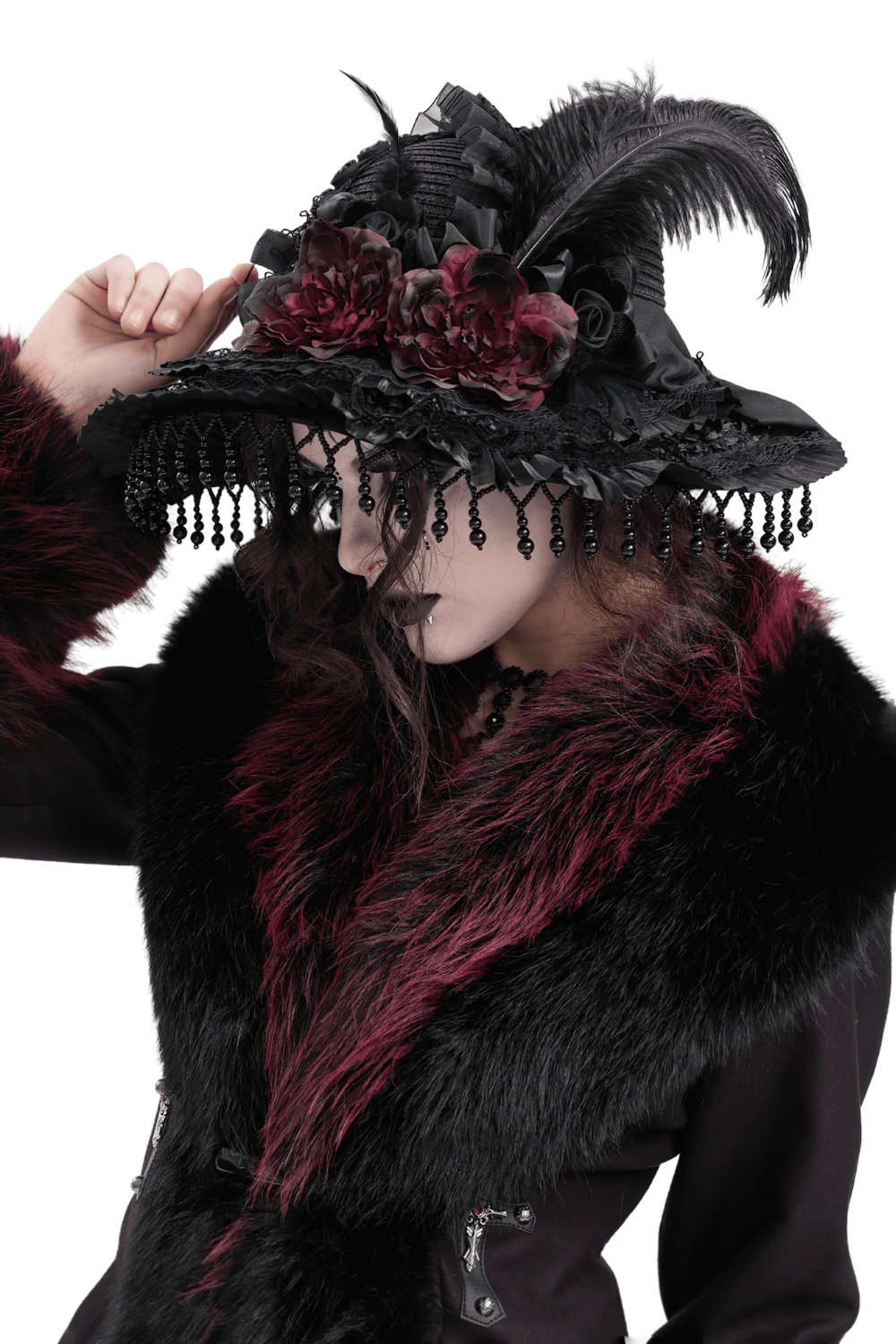 Vintage Victorian Gothic hat with feathers, lace, and beaded trim worn by a model in an elegant outfit.