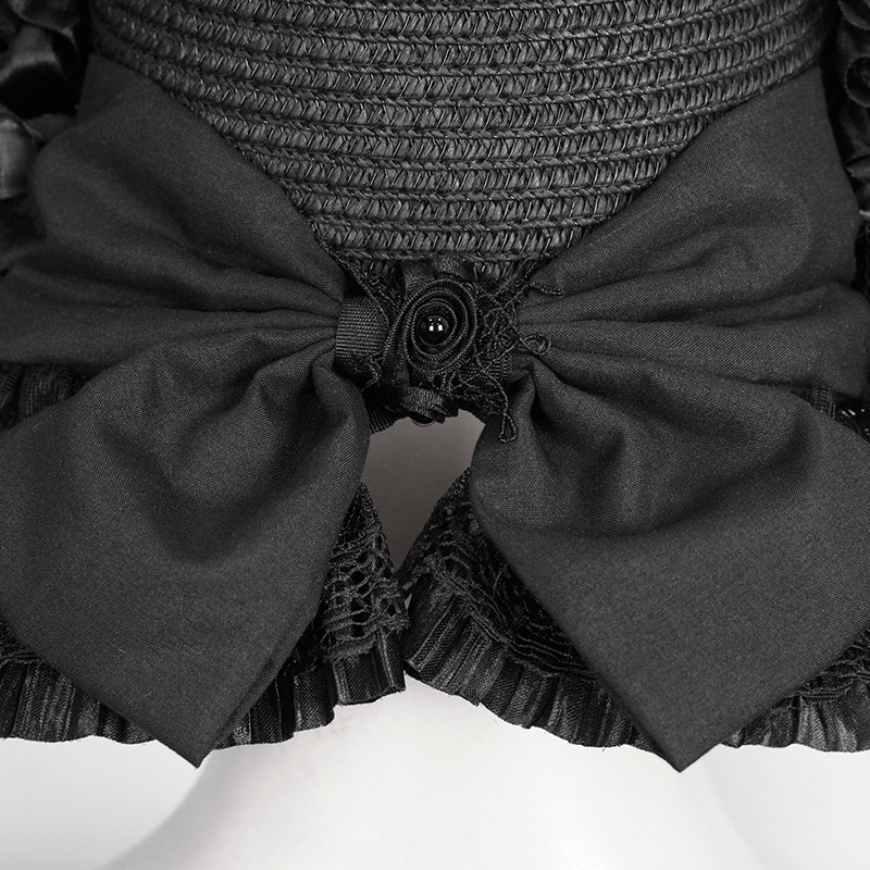 Elegant black dress detail featuring oversized bows and lace accents for a gothic vintage look.