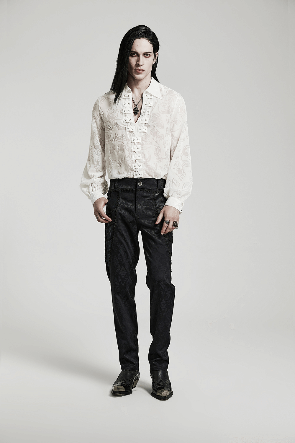 Model in Victorian-style shirt and black pants showcasing goth elegance and style.