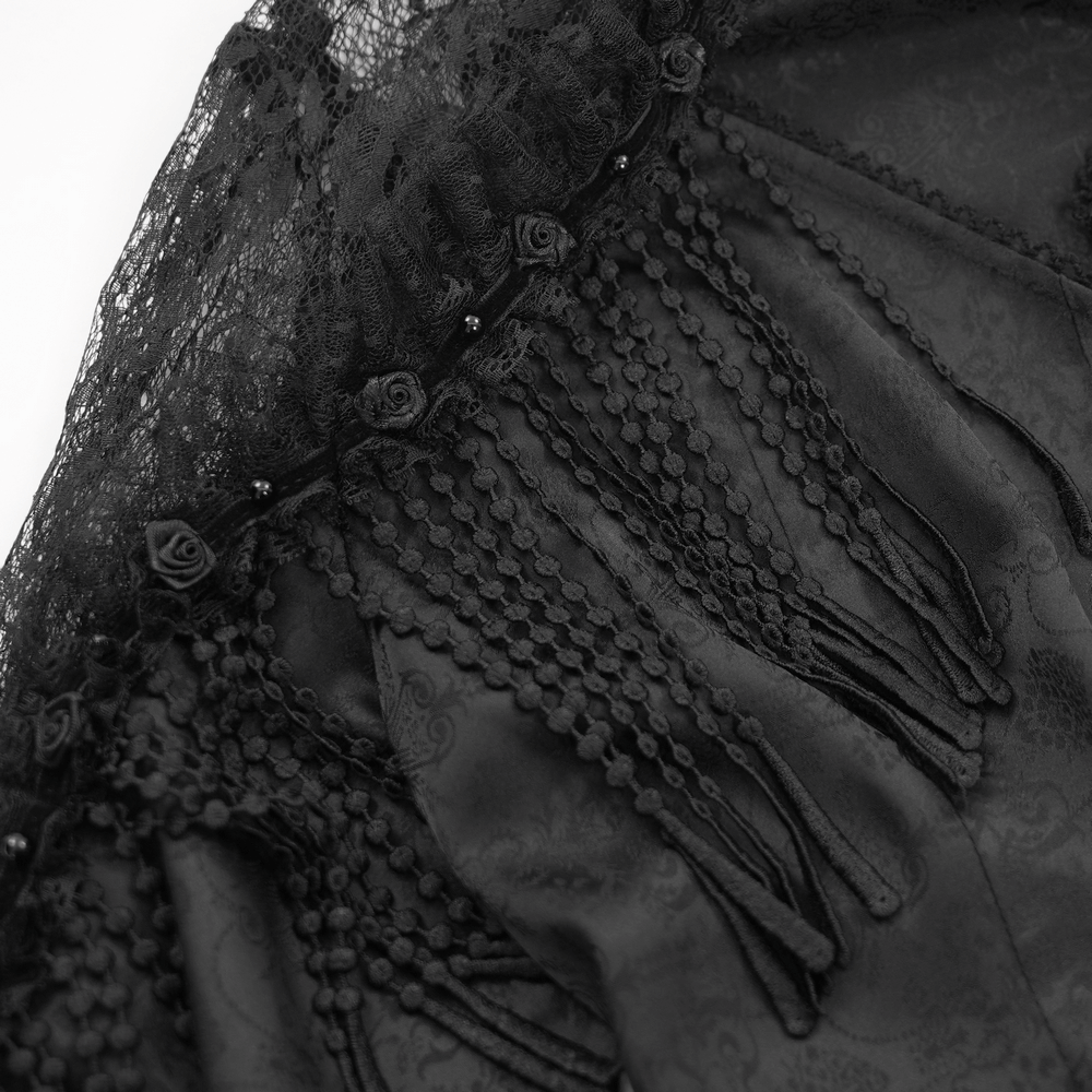 Close-up of Victorian gothic lace blouse featuring intricate beaded tassels and floral accents in elegant black.