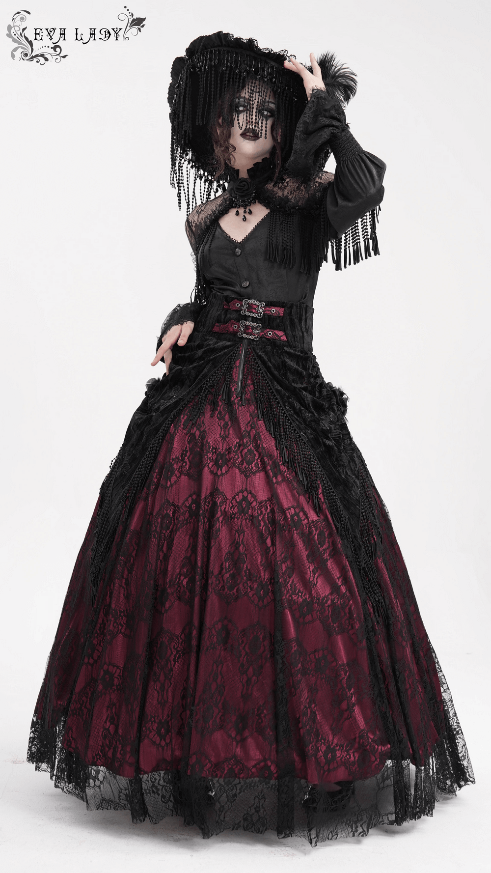 Elegant model in a Victorian gothic lace gown with dramatic black and burgundy detailing, featuring intricate lace and fringe accents.