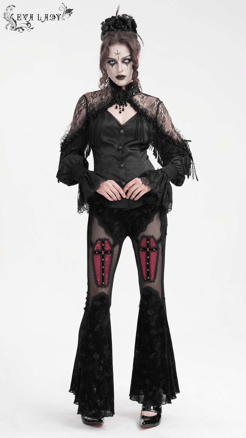 Elegant model in Victorian gothic lace blouse and dramatic black flared pants with beaded accents, showcasing a striking style.