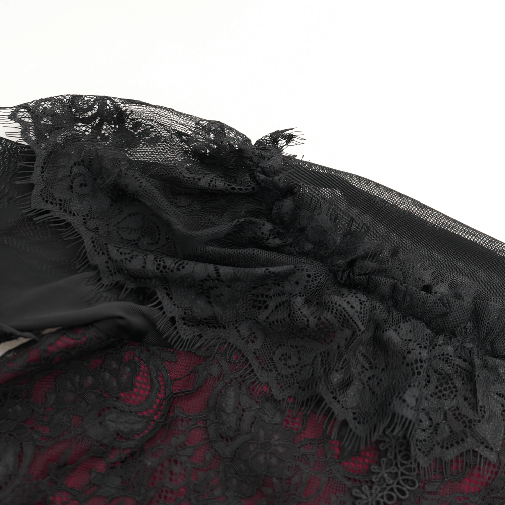 Close-up of intricate black lace trim on a Victorian Gothic blouse with rich red lining, evoking romantic elegance.