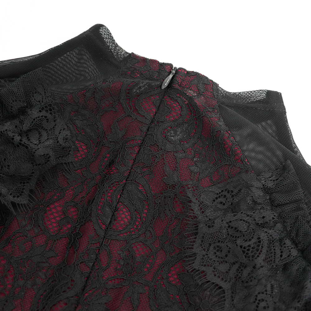 Close-up of Victorian Gothic lace blouse with sheer sleeves and intricate floral lace detail over rich red lining.