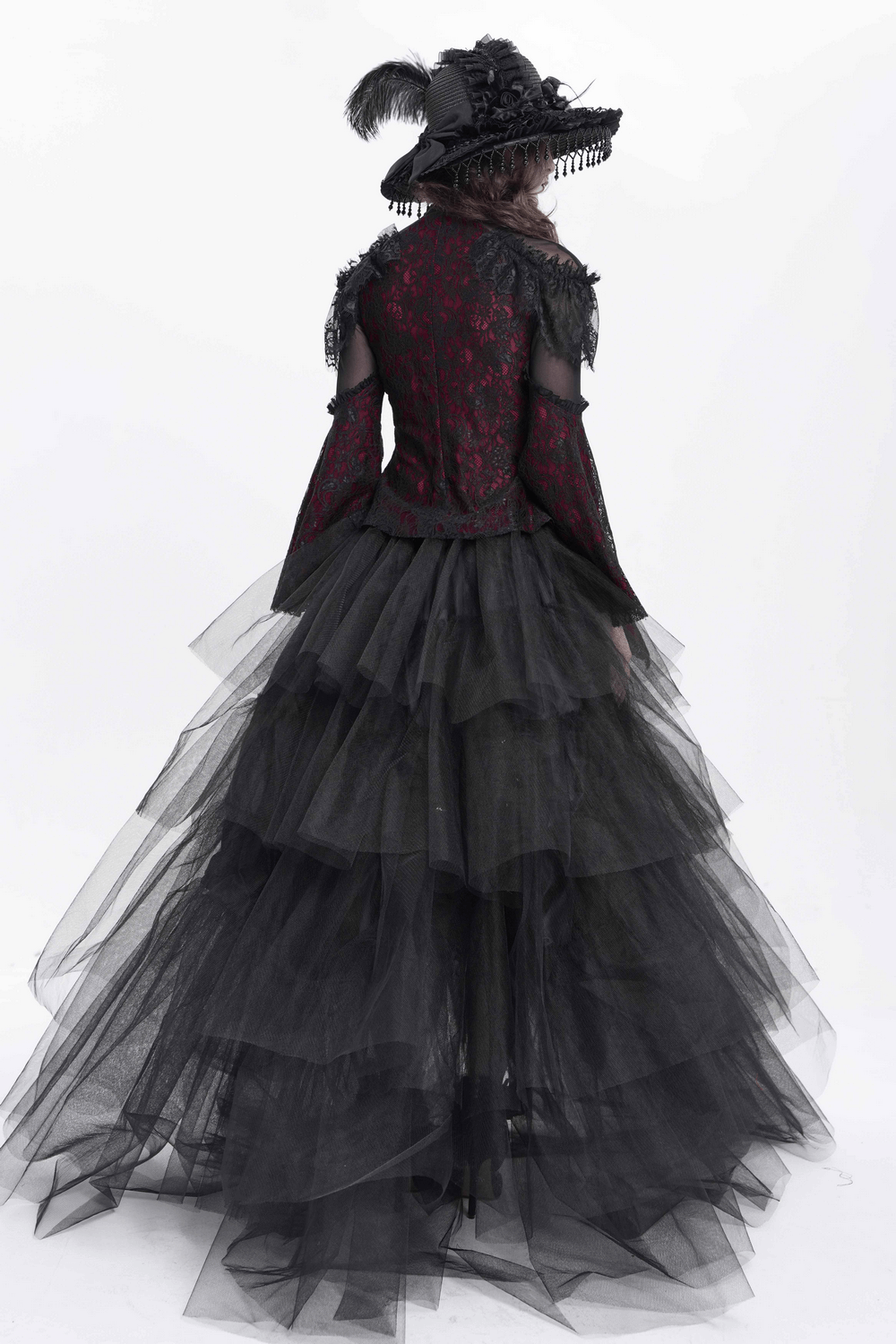 Back view of a Victorian Gothic dress with layered tulle skirt and elegant black hat, perfect for romantic occasions.