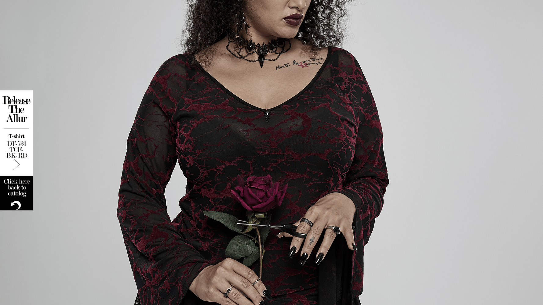 Gothic beauty wearing a black and red lace top, holding a rose, adorned with jewelry and a choker, blending elegance and mystery.