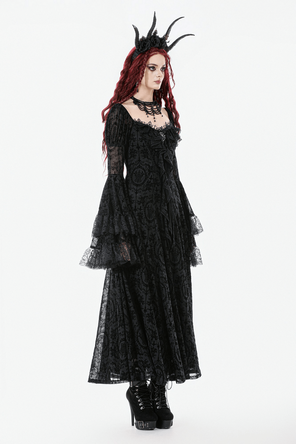 Victorian Gothic Lace Maxi Dress with Bell Sleeves worn by a model with red hair and a dramatic crown.