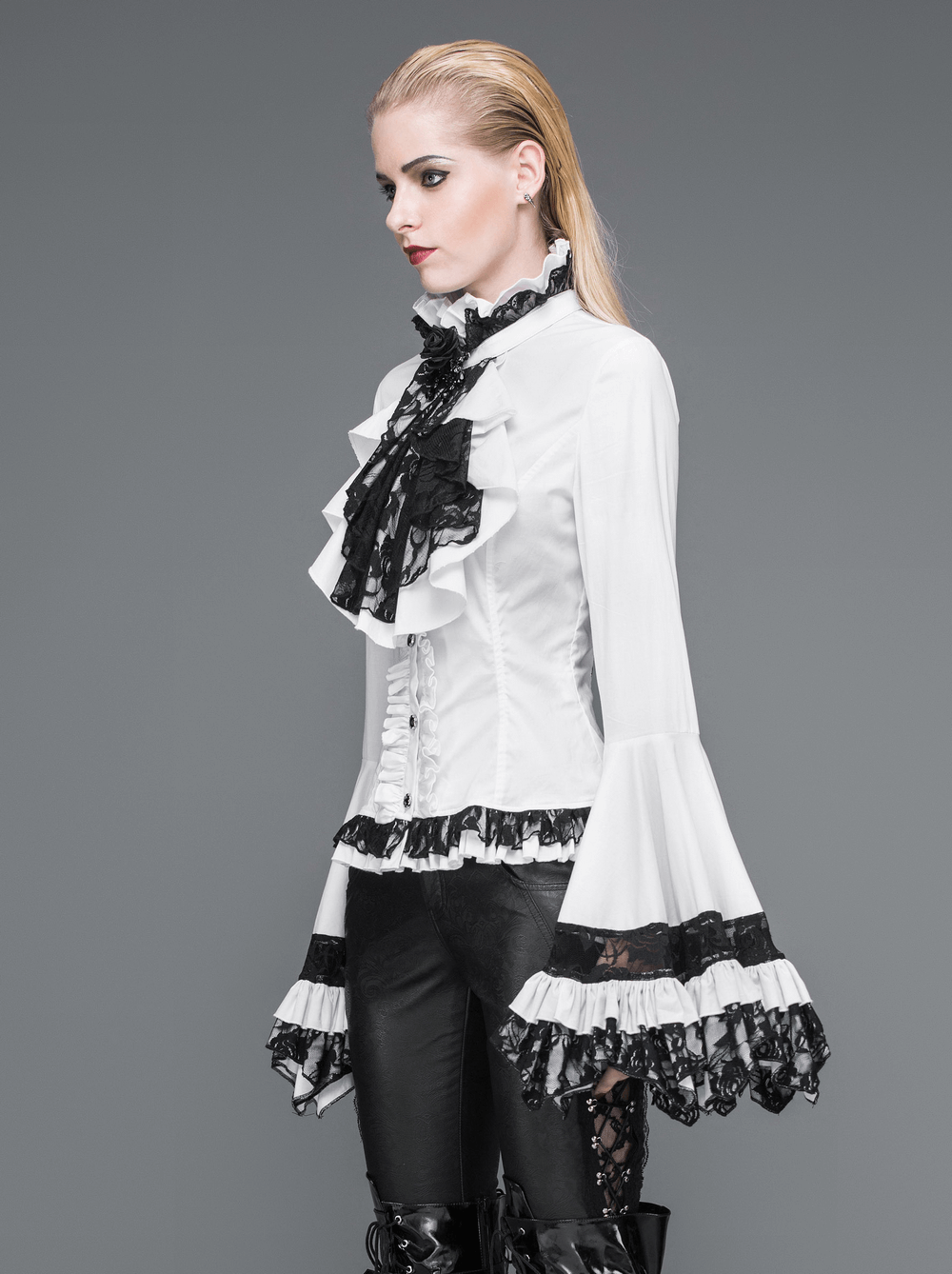Victorian Gothic lace ruffle blouse with black tie neck, featuring dramatic sleeves and intricate details.